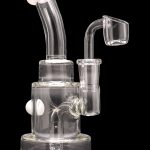 Clear glass dab rig with bubbler and quartz banger.