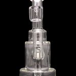Clear glass dab rig with multiple percolators, isolated on a black background.