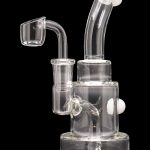 Clear glass dab rig with quartz banger, isolated on a black background.