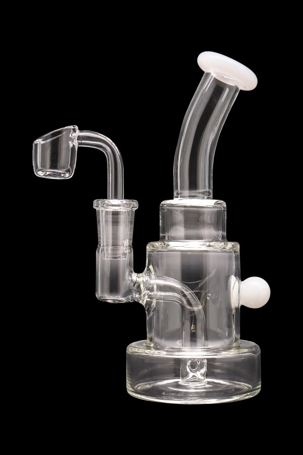 Clear glass dab rig with a quartz banger and white accents, isolated on a black background.