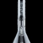 Clear glass water pipe (bong) with ice catch and brand logo, reflecting on a dark surface.