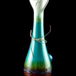 Hand-blown glass bubbler with teal and brown marbling, tied with twine.