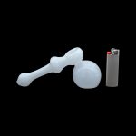 Glass bubbler pipe and lighter on a black background.