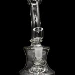 Clear glass bubbler water pipe against a black background.