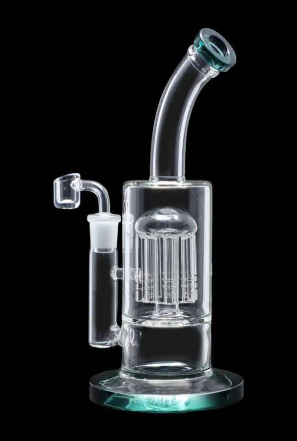 Clear glass bubbler with intricate perc diffusion and turquoise accents, isolated on black.