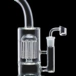 Clear glass water pipe (rig) with a complex perc filtration system and a quartz banger.