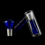 Blue glass bubbler and water pipe against a black background.