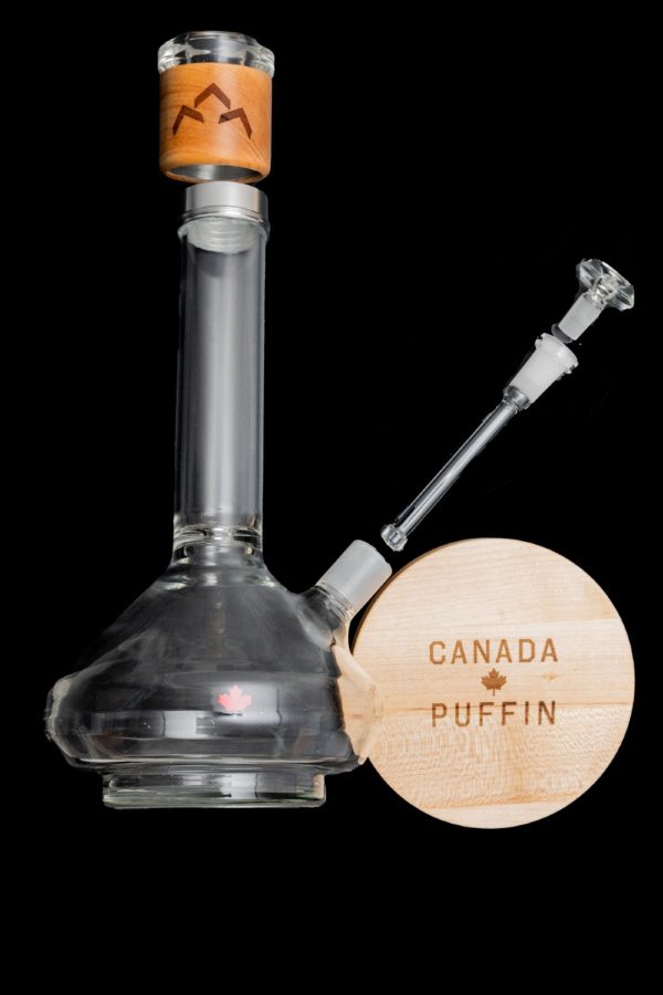 Glass water pipe (bong) with wooden base displaying “Canada Puffin” logo.