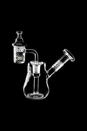 The Compact Travel Etched Dab Rig Set is displayed in a close-up, angled view, showcasing its etched glass details and compact size.