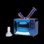 Iridescent glass water pipe shaped like a vintage television with a separate glass bowl.
