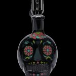 Black glass water pipe shaped like a sugar skull with colorful floral detailing.