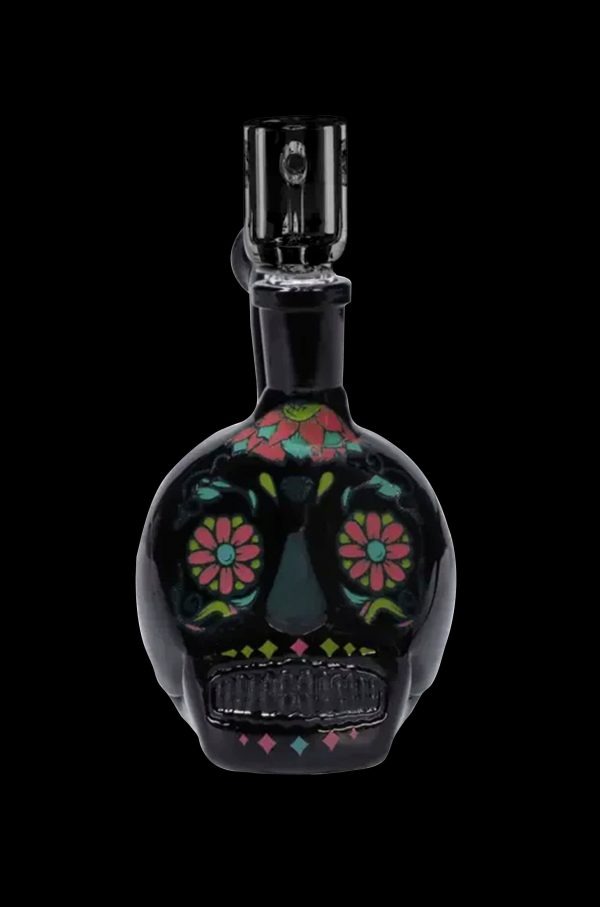 Black glass water pipe shaped like a sugar skull with colorful floral detailing.