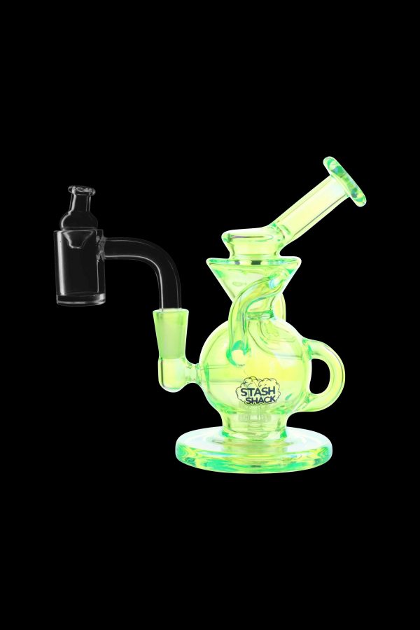 Glowing green glass dab rig with a quartz banger, branded “Stash Shack.”
