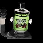 Green glass water pipe shaped like Frankenstein's monster.