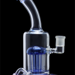 Blue glass water pipe (bong) with diffuser and accessories on black background.