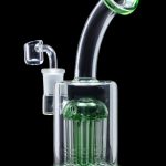 Green glass water pipe (rig) with multiple percolators, isolated on a black background.