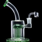 Green glass dab rig with multiple diffusion stacks, isolated on a black background.