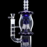 Blue and clear glass water pipe (bong) with multiple diffusion chambers against a black background.