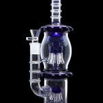 Blue glass water pipe (bong) with intricate percolators, isolated on a black background.