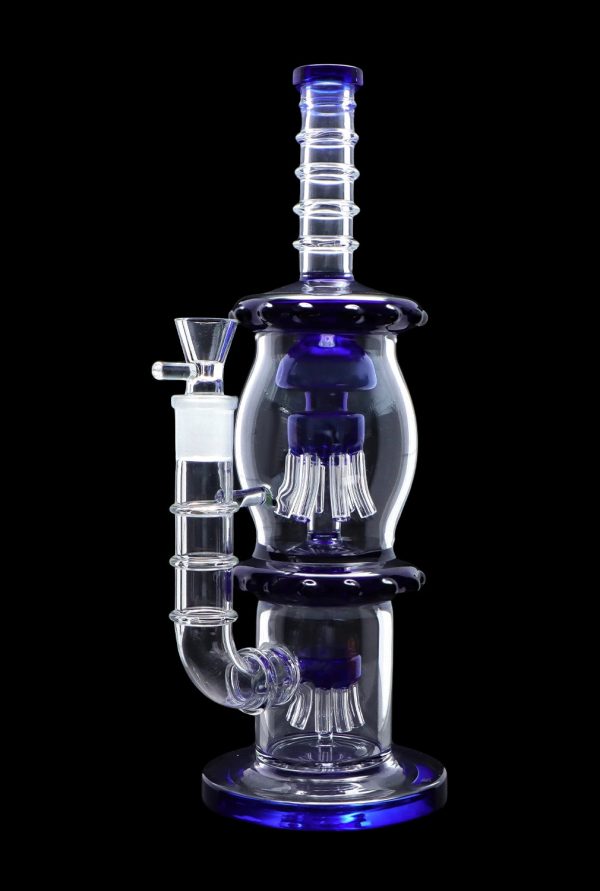 Blue glass water pipe (bong) with intricate percolators, isolated on a black background.