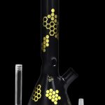 Black glass bong with gold honeycomb pattern, accompanied by a downstem and bowl.