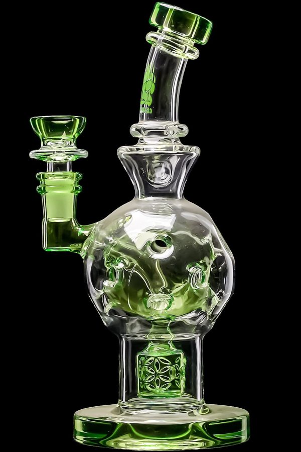Green glass water pipe (bong) with intricate floral designs, isolated on a black background.