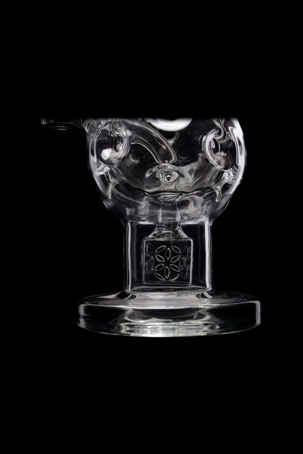 Clear glass dab rig with intricate floral detailing, isolated on a black background.