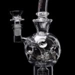 Clear glass water pipe (rig) with intricate bubble design, isolated on black.
