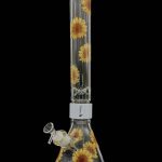 Glass bong with sunflower design against a black background.