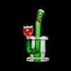 Green glass water pipe shaped like a retro video game character with a red flower-shaped bowl, isolated on a black background.