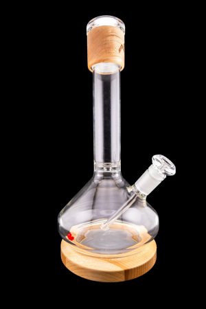 Glass water pipe (bong) with a wooden base and mouthpiece, isolated on a black background.
