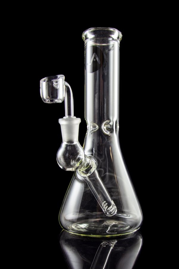 Clear glass water pipe (bong) with a quartz banger, studio shot on a black reflective surface.