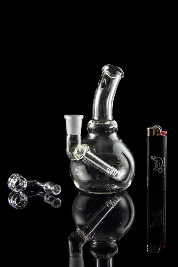 A studio shot of the LA Pipes Mini Bubble Base Concentrate Rig, reflecting on a dark surface with a sleek, modern aesthetic.