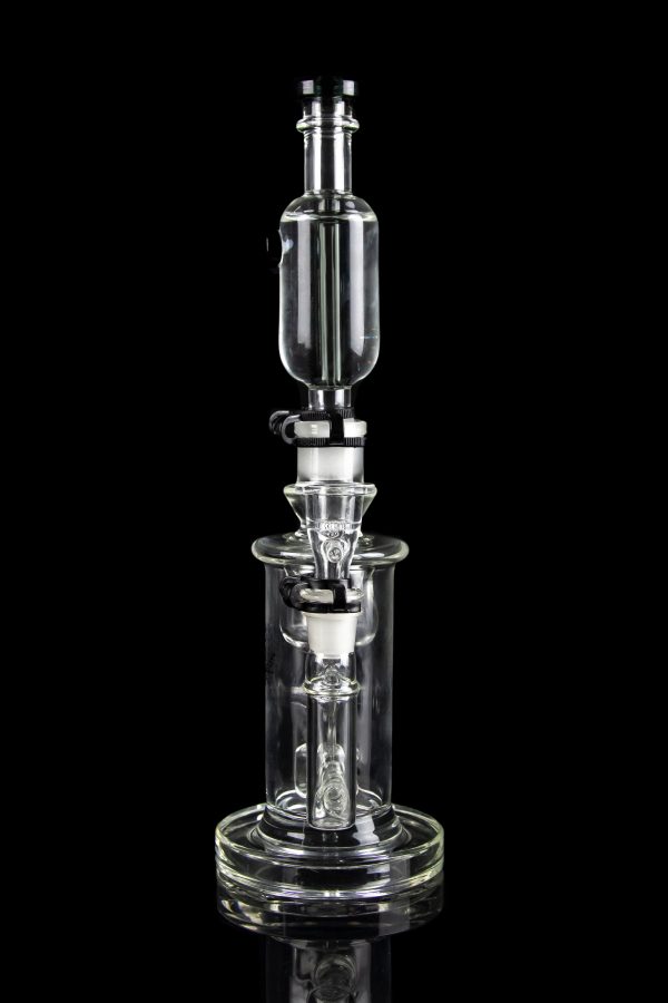 Clear glass dab rig with intricate percolator chambers, isolated on a black background.