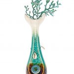 Front view of the “My Bud Vase “Mermaid” Water Pipe”, showcasing a uniquely shaped glass piece with blue accents resembling ocean coral.
