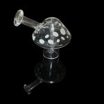 Clear glass mushroom-shaped oil rig with speckled cap, isolated on black.