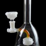 Clear glass water pipe (bong) with rainbow and cloud-shaped percolators, and separate glass bowl, isolated on black.