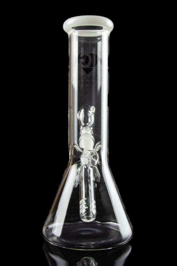 Clear glass bong with intricate sculpted artwork inside, reflecting on a glossy black surface.
