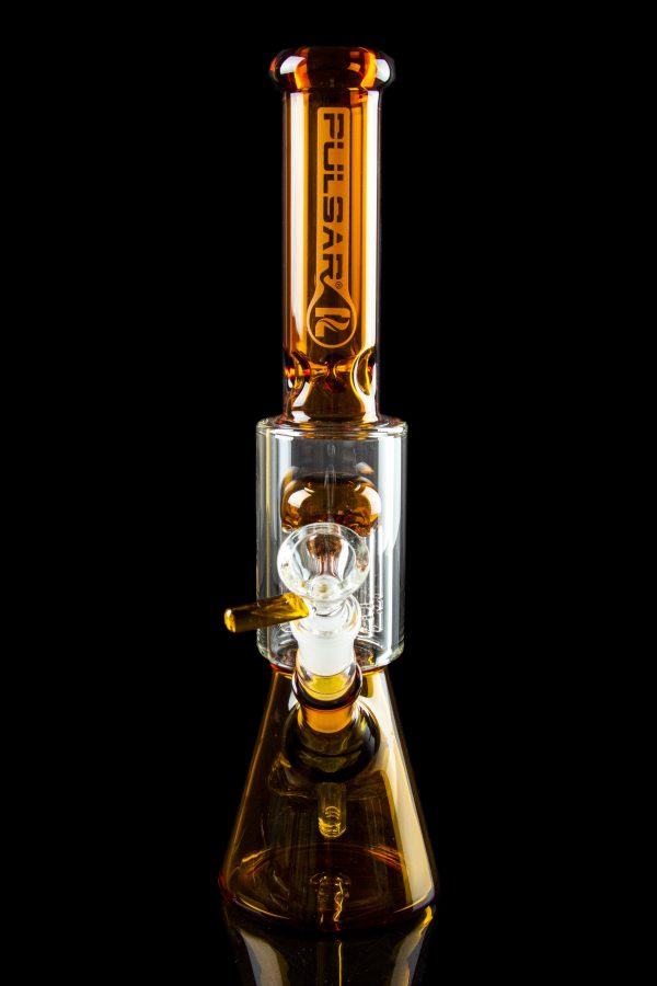 Amber glass water pipe (rig) with intricate clear glass percolator and “Pulsar” logo, isolated on black.