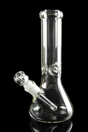 Clear glass bong with a downstem, reflecting on a black surface.