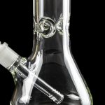 Clear glass water pipe (bong) with intricate design against a black background.