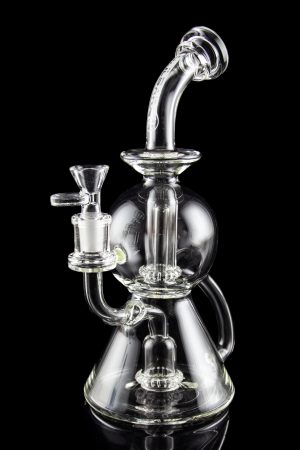 Clear glass water pipe (rig) with intricate bubbler design, isolated on black.
