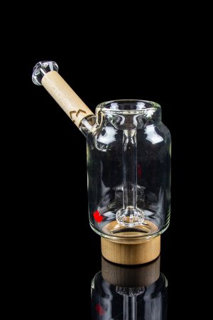 Clear glass water pipe with a wooden base and mouthpiece, isolated on a black background.