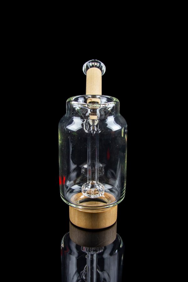 Clear glass water pipe with a wooden base and intricate internal diffusion system, studio shot on black.