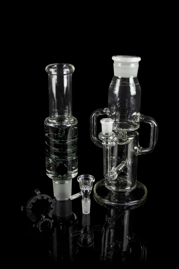 Clear glass bongs and smoking accessories displayed on a black reflective surface.