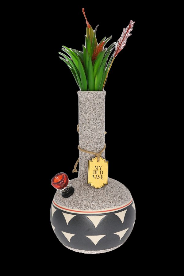 A decorative glass bong resembling a vase, adorned with faux botanical sprigs and a label reading “My Bud Vase.”"
