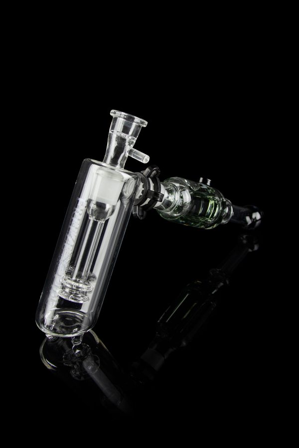 Clear glass bubbler and oil rig with intricate design, isolated on black.