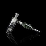 Glass rig with bubbler and connection for dabbing, isolated on black.