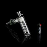 Glass bubbler water pipe with intricate design against a black background.