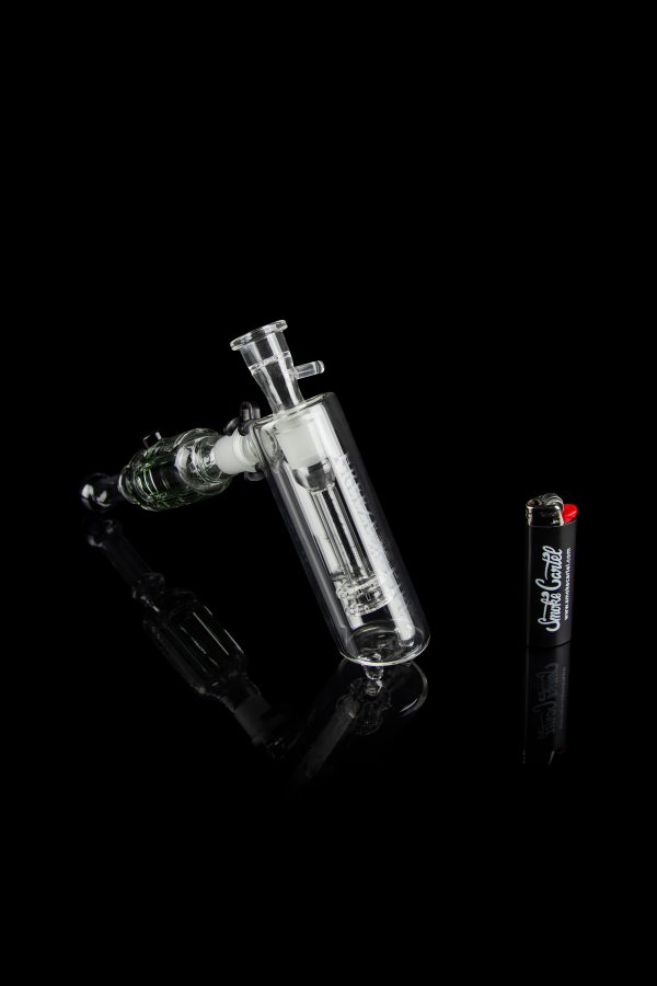 Glass bubbler water pipe with intricate design against a black background.
